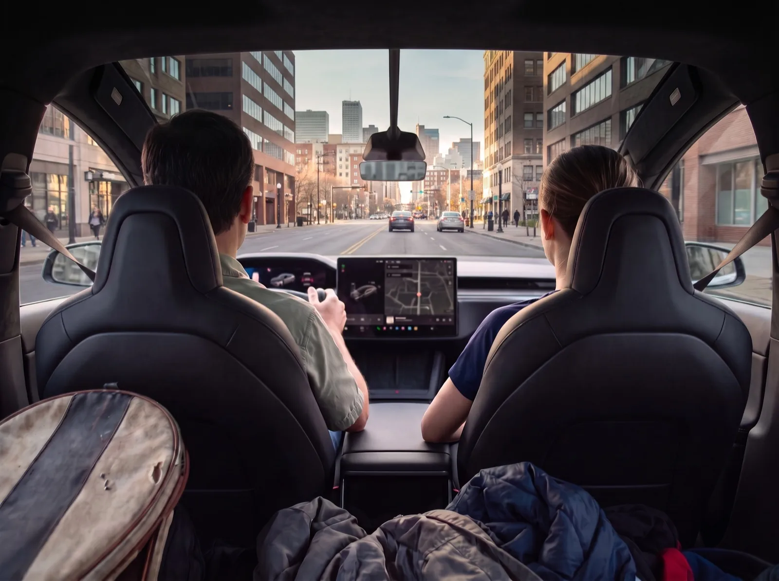 Illustrative back-seat view of a parent and junior tennis player riding home in a Tesla Model X, both seen from behind, with a city street through the windshield